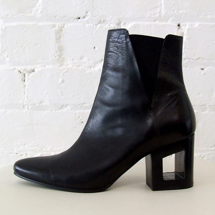 Black leather ankle boot with cut-out heel.