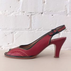 Red leather peep-toe sandal with ankle strap and contrast stitching.