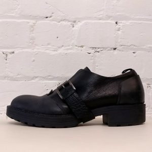Heavy black leather Muflone shoe with over-buckle, has box.