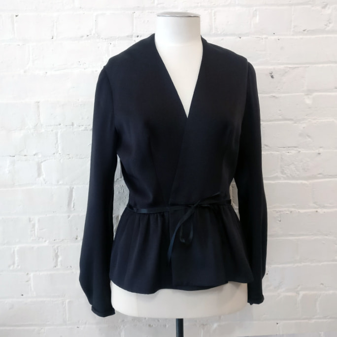 100% silk tie-front collarless jacket with peplin.