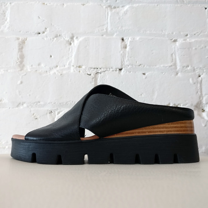 Platform slip-on scuff with leather cross-over.