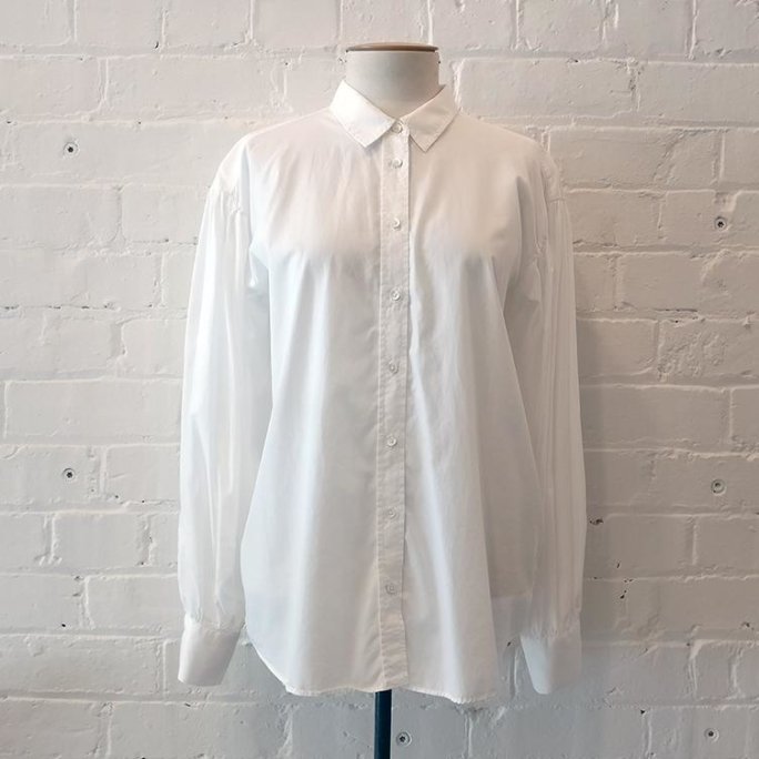 White shirt with pintuck sleeve detail.