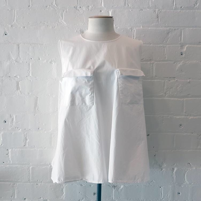Flared shell top with patch pockets.