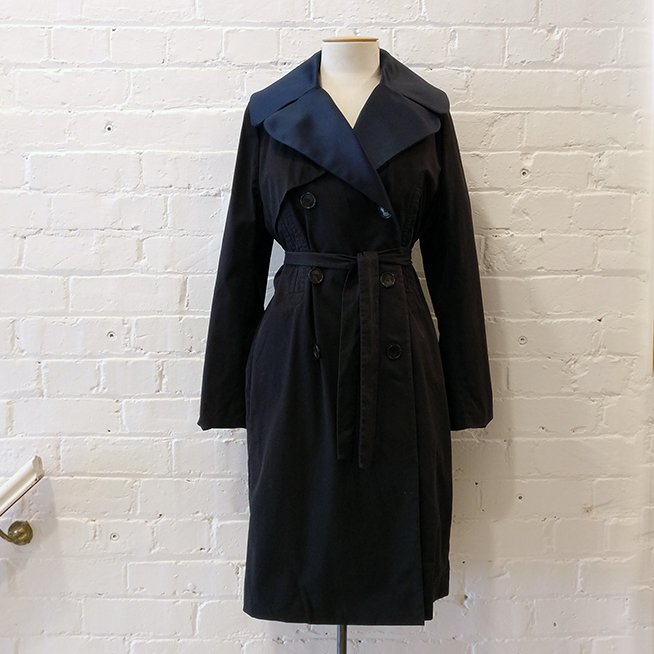 Double-breasted canvas trench coat with contrast collar, unlined.
