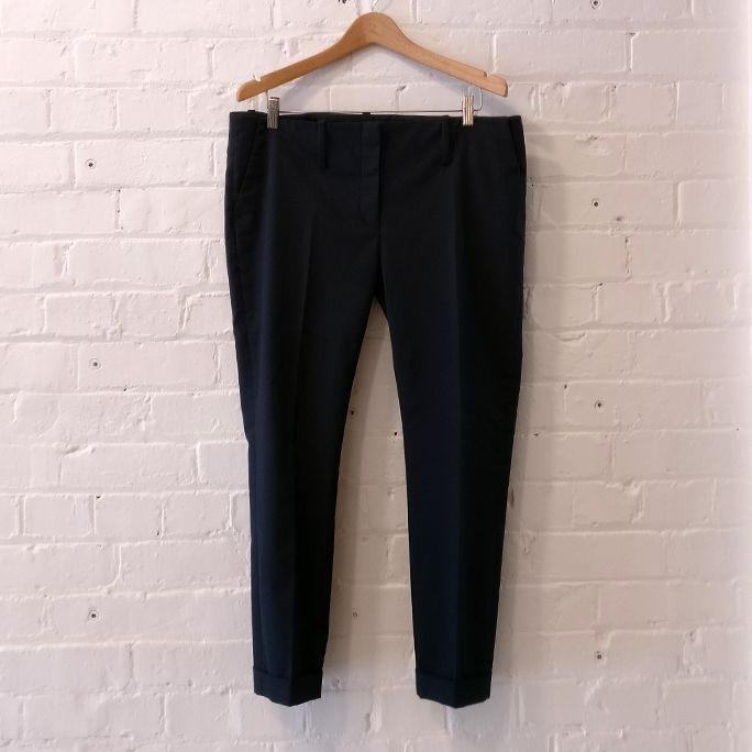 Flat-front taper trouser with cuff and pockets.