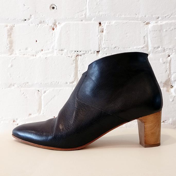 Black leather ankle boot with wooden heel.