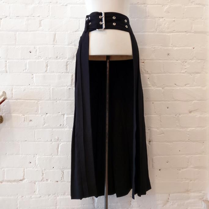 Pleated half skirt with heavy buckle.