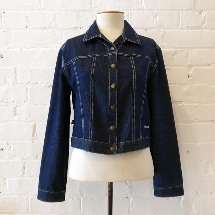Denim jacket with contrast stitching and domes.