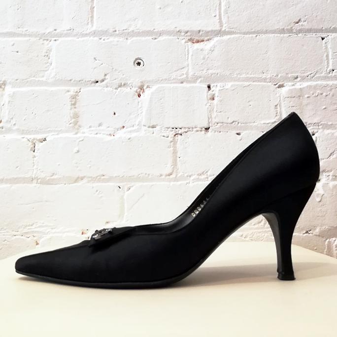 Black satin heels with diamante pin.
