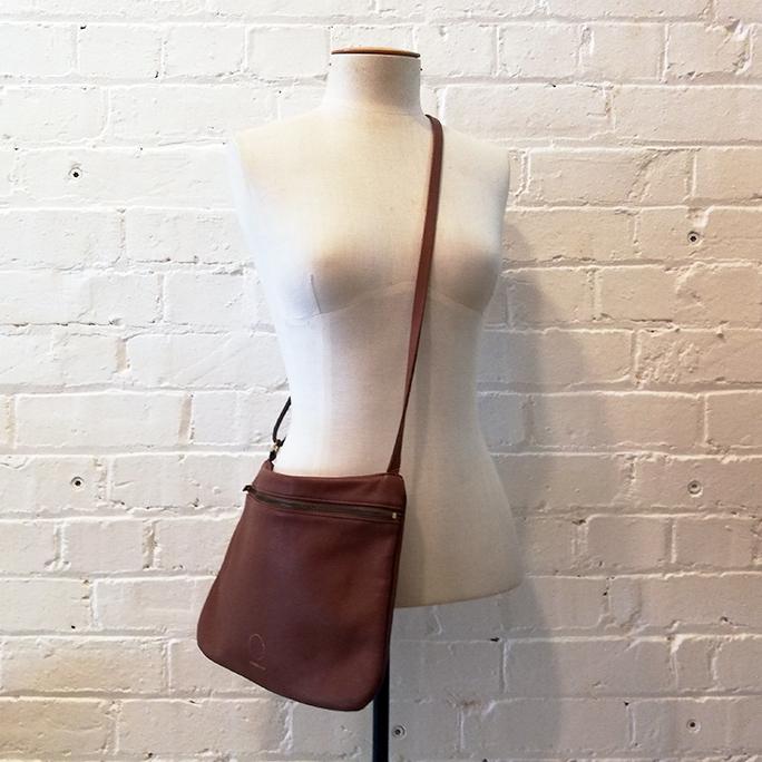 Textured leather cross-body satchel.
