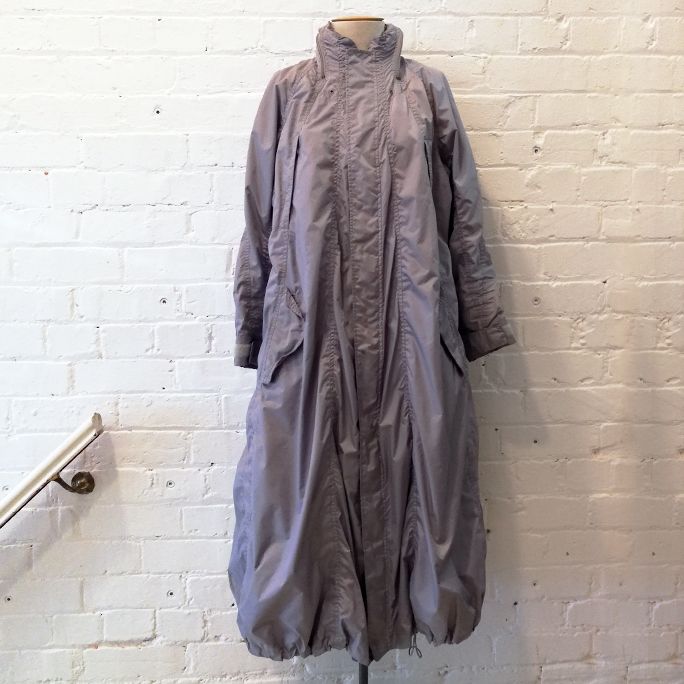 Rain coat with multiple pockets and stash hood, fully lined.