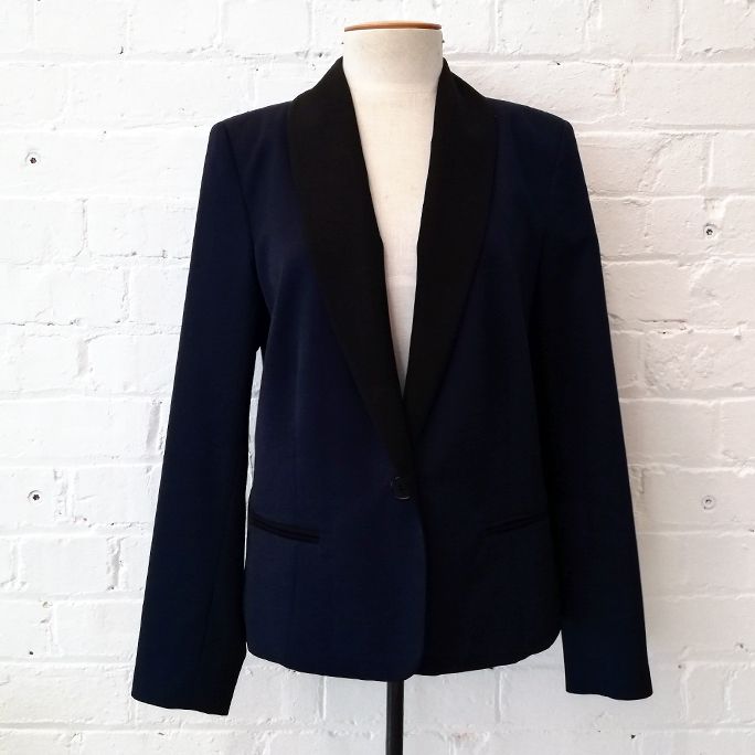 Single-button navy tuxedo jacket with black lapel.