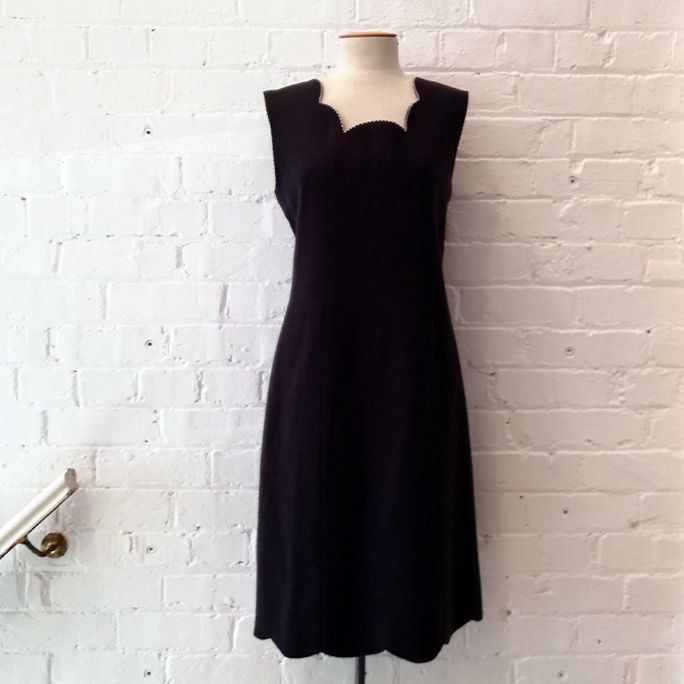 Grey wool shift dress with scalloped neck line, fully lined.