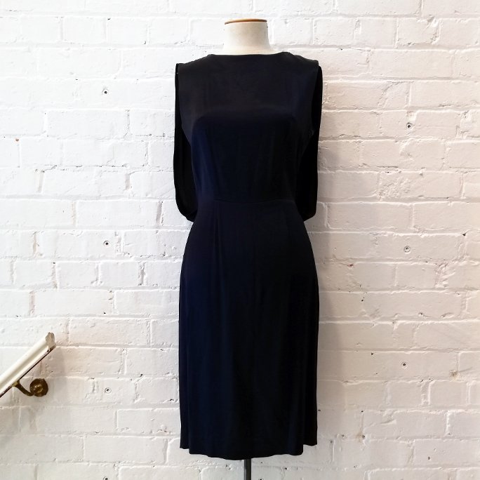 Sleeveless shift dress with gathered back.