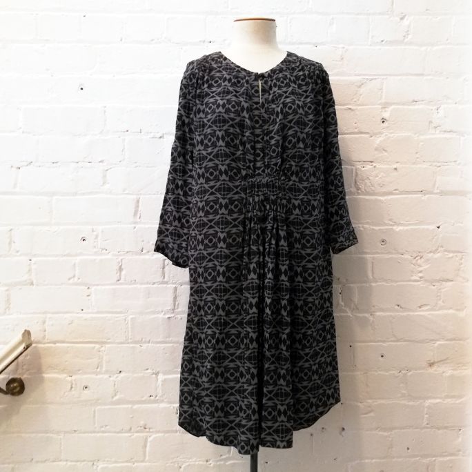 3/4 sleeve dress with pleated front and geometric print.