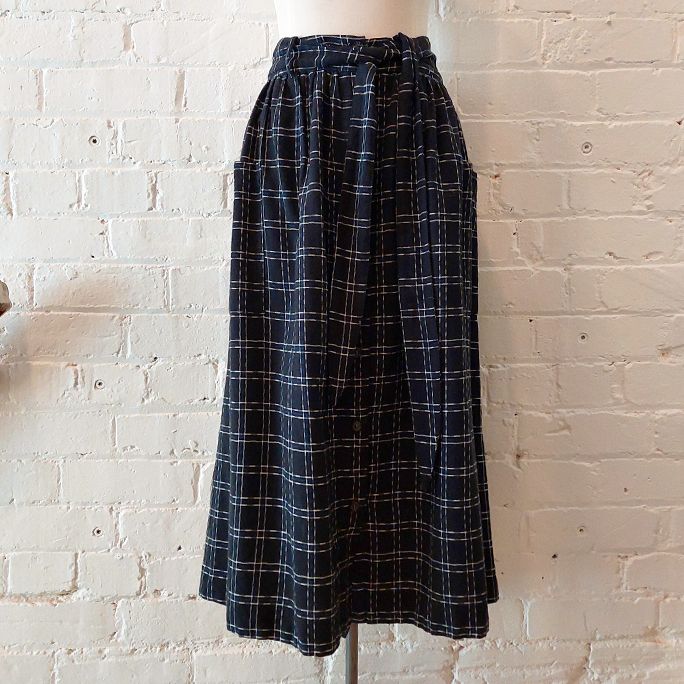 Button-front skirt with patch pockets and fabric belt.