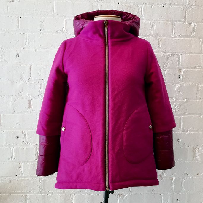 Reversible puffer/wool jacket with detachable hood.