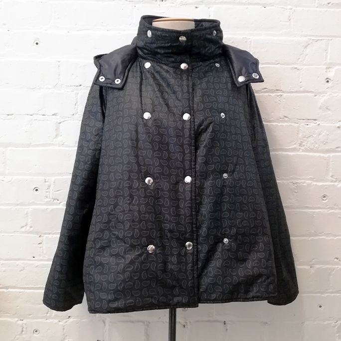 Reversible puffer jacket with detachable hood.