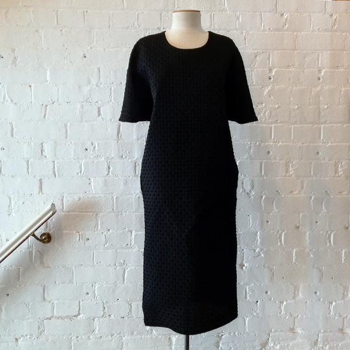 "Capsule" textured fabric dress with pockets.