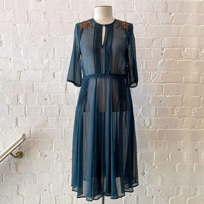 Light silk dress with embellished shoulders.