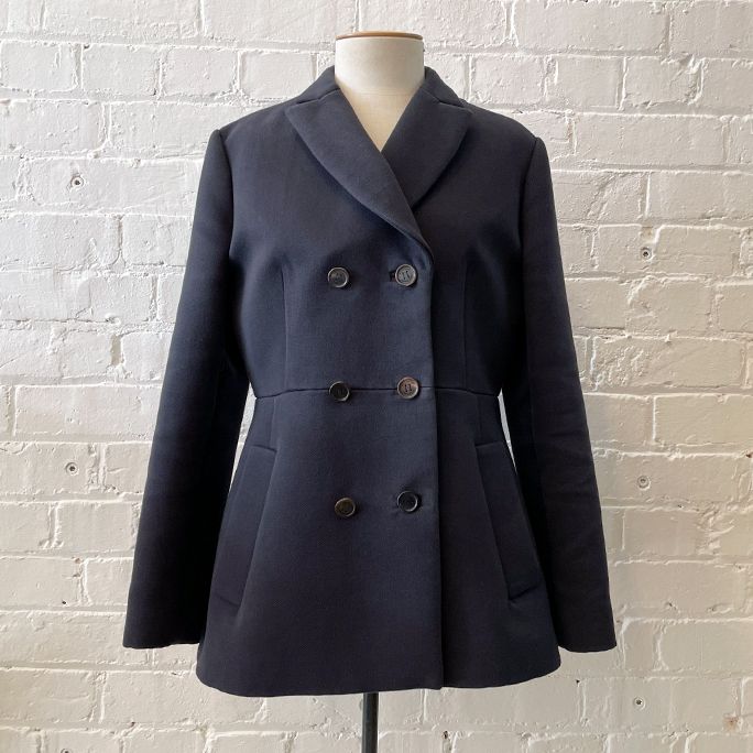 Structured short coat with pockets, fully lined.