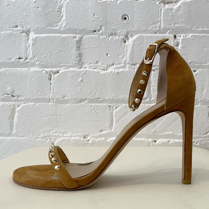 High heel camel suede shoe with ankle strap and studs.
