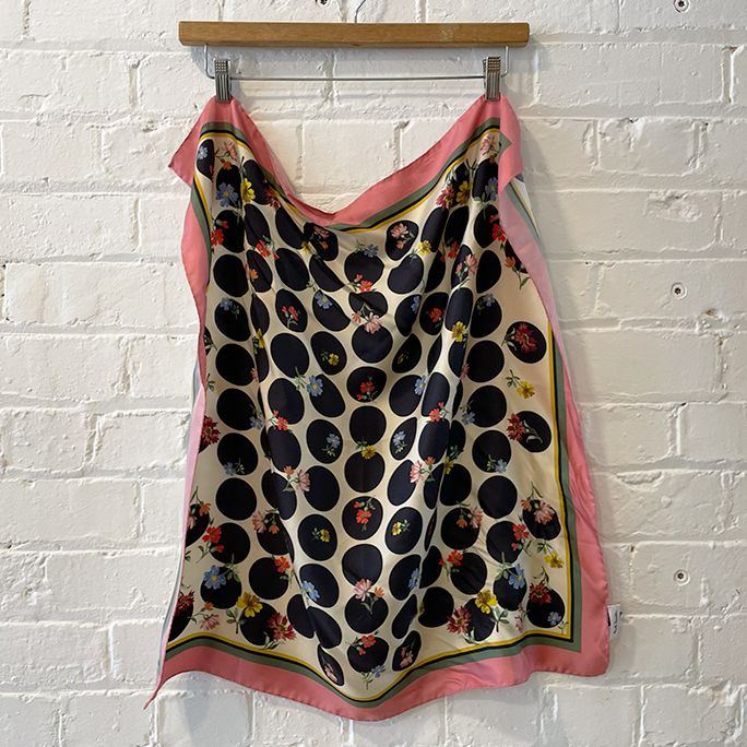 Silk scarf with floral motif and rolled edge.