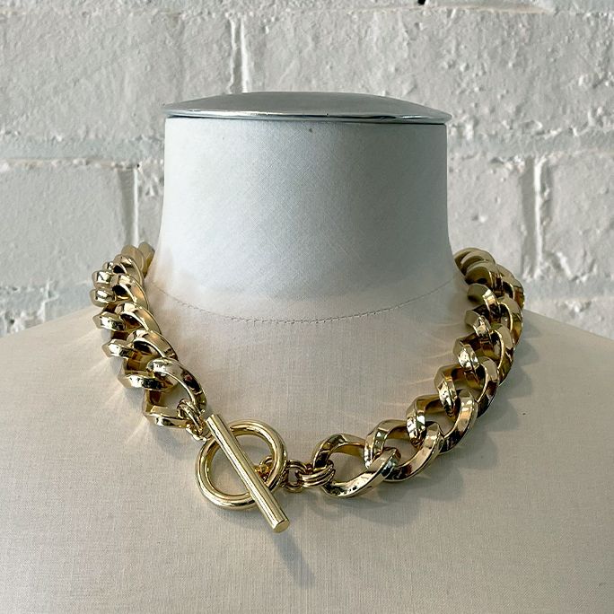 Chunky golden chain with fob.